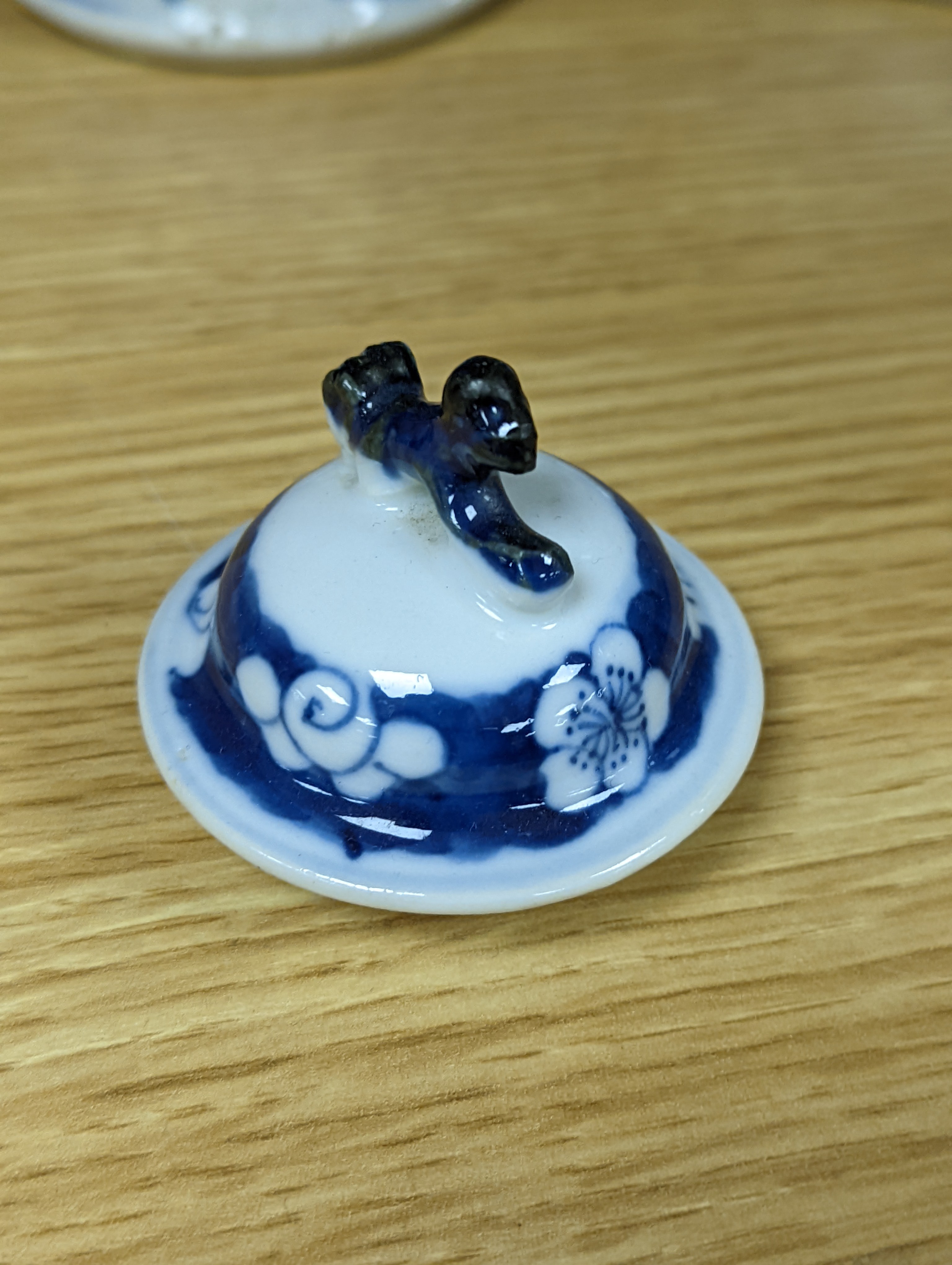 A pair of 19th century Chinese blue and white vases, a prunus vase and cover and a similar jar (4), pair of vases 24 cms high.